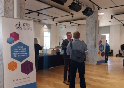Photo of two people in conversation during a rest break at a medical conference