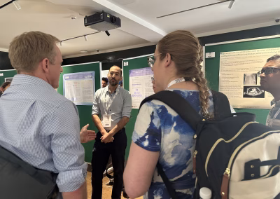 Photo ofa person presenting an abstract in front of exhibition stands