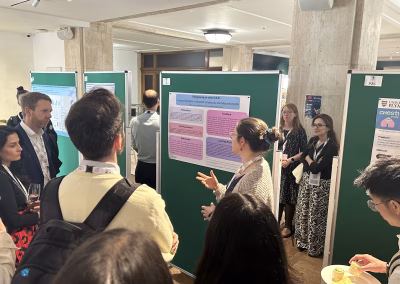 Photo of people in conversation in front of exhibition stands